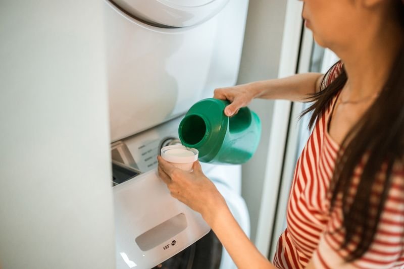 Laundry treatment being poured into a machine